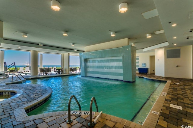 indoor pool featuring a patio