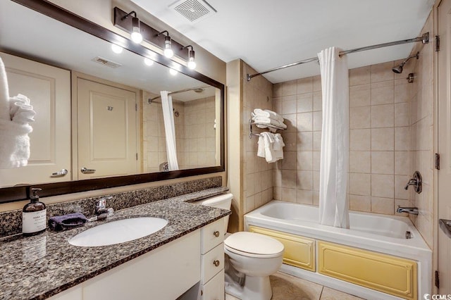 bathroom with shower / bath combo with shower curtain, tile patterned flooring, vanity, and toilet