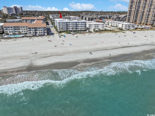 aerial view featuring a water view, a view of city, and a view of the beach
