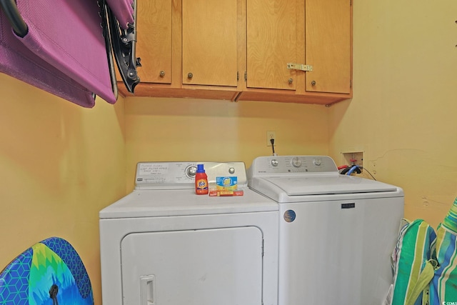 laundry area featuring washer and dryer and cabinet space