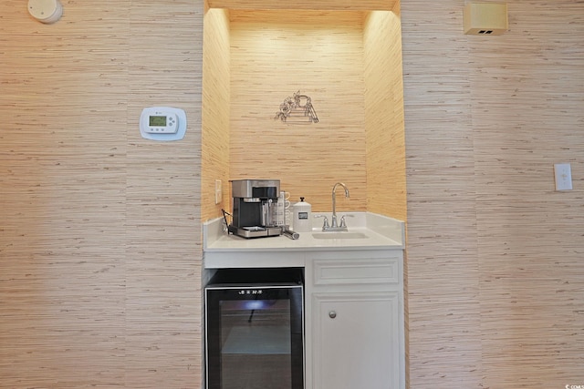bar featuring a sink, wet bar, and beverage cooler