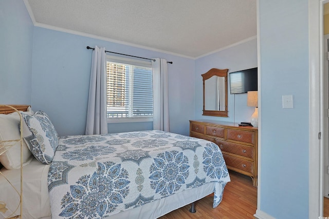 bedroom with crown molding and wood finished floors