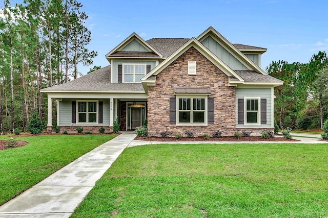 6013 Blease Ct, Myrtle Beach, SC 29588 - craftsman house featuring board and batten siding, stone siding, a shingled roof, and a front yard