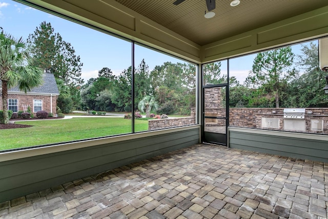 6013 Blease Ct, Myrtle Beach, SC 29588 - unfurnished sunroom featuring area for grilling, ceiling fan, and view of scattered trees