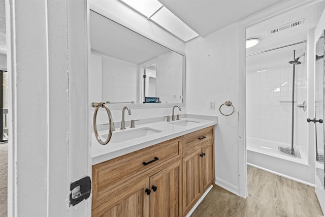 7300 Porcher Dr Unit 11, Myrtle Beach, SC 29572 - bathroom featuring wood finished floors, double vanity,  shower combination, and baseboards