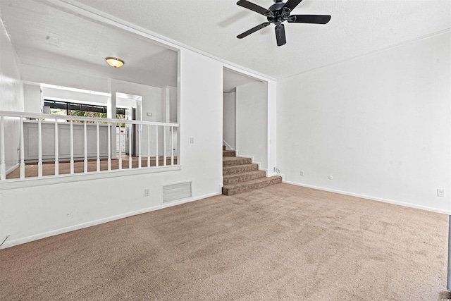7300 Porcher Dr Unit 11, Myrtle Beach, SC 29572 - carpeted empty room featuring a ceiling fan, baseboards, stairway, and a textured ceiling