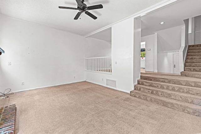 7300 Porcher Dr Unit 11, Myrtle Beach, SC 29572 - unfurnished living room with stairs, ceiling fan, carpet, a textured ceiling, and baseboards