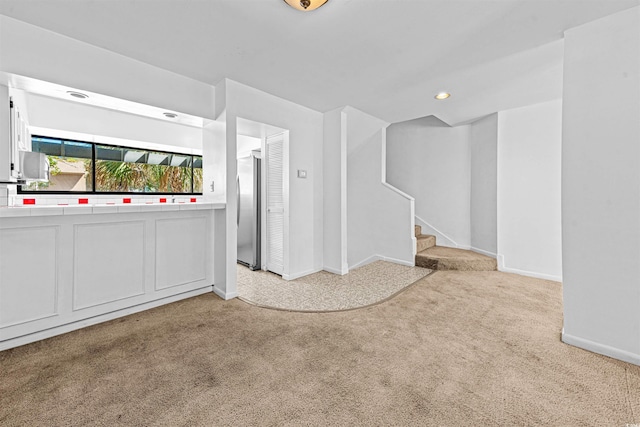 7300 Porcher Dr Unit 11, Myrtle Beach, SC 29572 - spare room with light carpet, baseboards, stairway, and recessed lighting