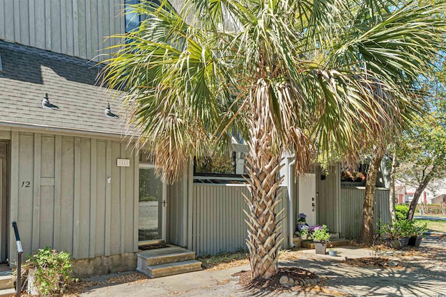 7300 Porcher Dr Unit 11, Myrtle Beach, SC 29572 - property entrance with a shingled roof and board and batten siding
