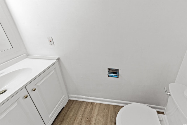 7300 Porcher Dr Unit 11, Myrtle Beach, SC 29572 - half bath featuring vanity, wood finished floors, toilet, and baseboards