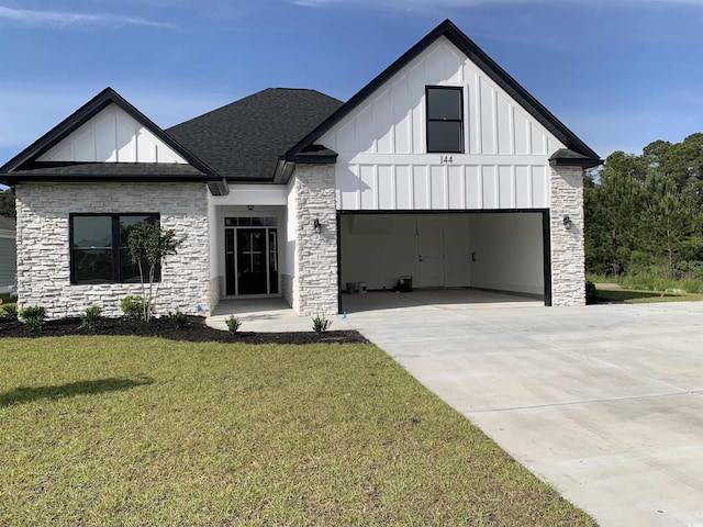 144 Sago Palm Dr, Myrtle Beach, SC 29579 - modern farmhouse style home with board and batten siding, driveway, a front lawn, and stone siding