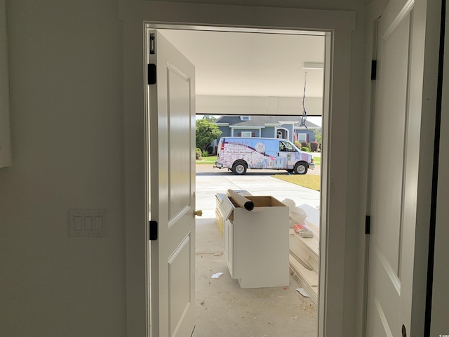 doorway to outside featuring unfinished concrete floors