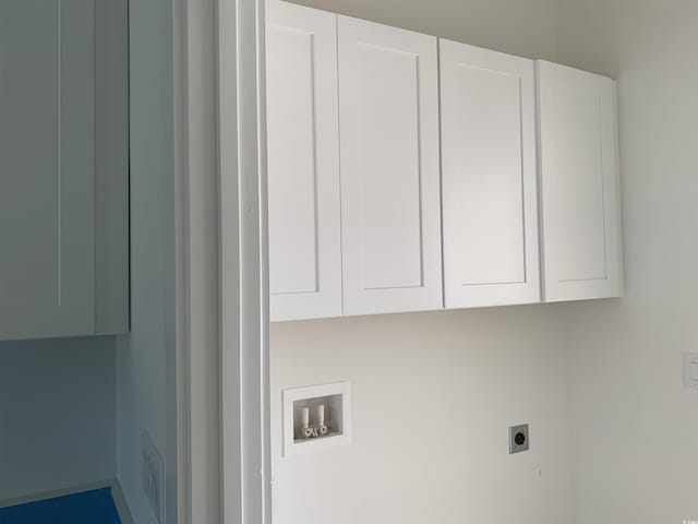 laundry room featuring electric dryer hookup, cabinet space, and hookup for a washing machine