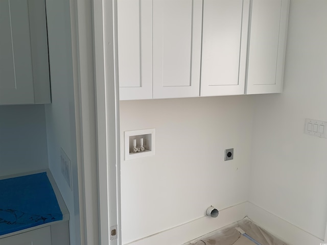 washroom with cabinet space, washer hookup, baseboards, and hookup for an electric dryer