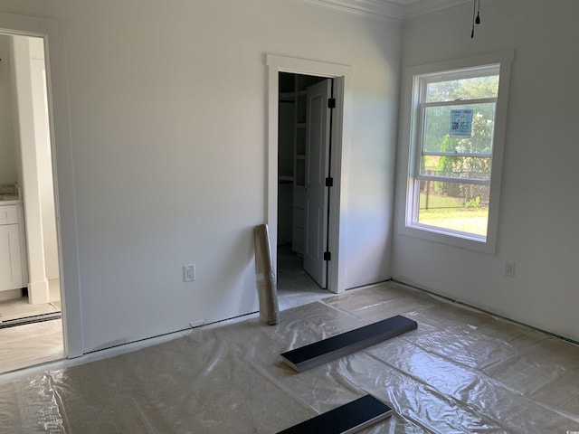 unfurnished bedroom featuring ornamental molding