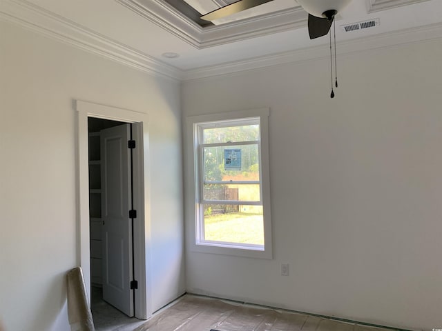 unfurnished bedroom with a tray ceiling, ornamental molding, and visible vents