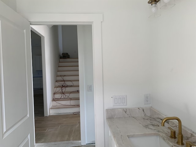 interior space with a sink and wood finished floors