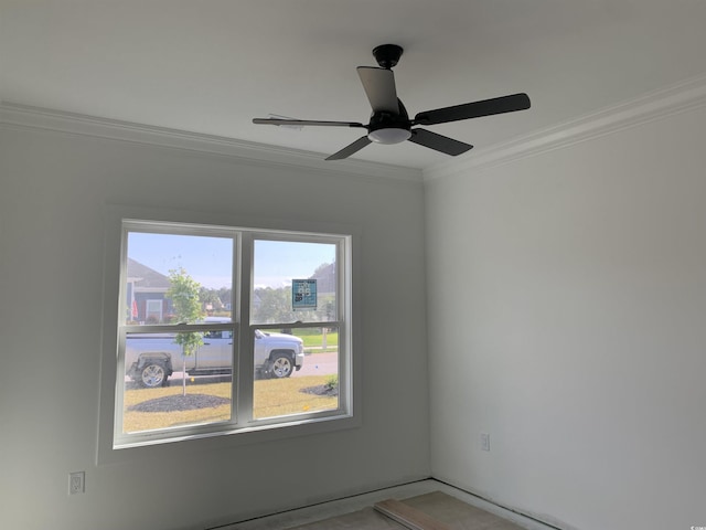empty room with crown molding and ceiling fan