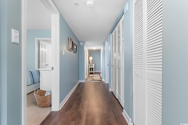 501 S Ocean Blvd Unit 1006, North Myrtle Beach, SC 29582 - hallway featuring dark wood finished floors, baseboards, and a textured ceiling