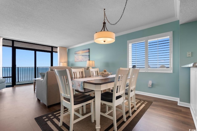 501 S Ocean Blvd Unit 1006, North Myrtle Beach, SC 29582 - dining area with a textured ceiling, dark wood-type flooring, plenty of natural light, crown molding, and baseboards