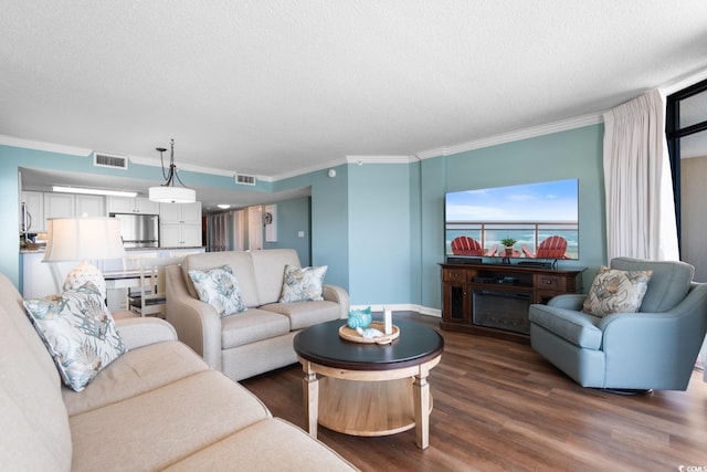 501 S Ocean Blvd Unit 1006, North Myrtle Beach, SC 29582 - living area with ornamental molding, dark wood-style floors, and a textured ceiling