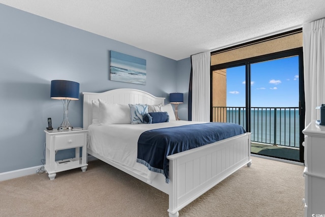 501 S Ocean Blvd Unit 1006, North Myrtle Beach, SC 29582 - carpeted bedroom with access to outside, a water view, a textured ceiling, and baseboards