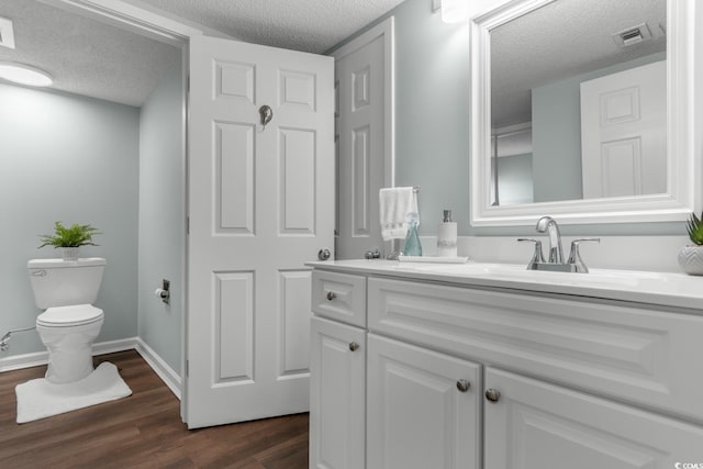 501 S Ocean Blvd Unit 1006, North Myrtle Beach, SC 29582 - bathroom with a textured ceiling, wood finished floors, vanity, toilet, and baseboards