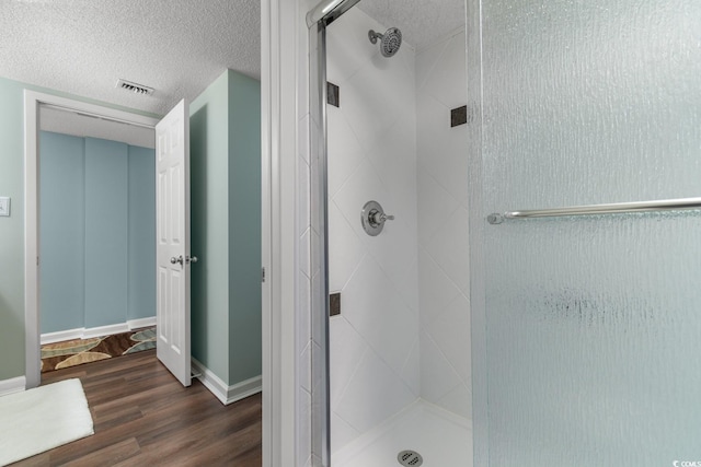501 S Ocean Blvd Unit 1006, North Myrtle Beach, SC 29582 - bathroom with a shower stall, wood finished floors, baseboards, and a textured ceiling