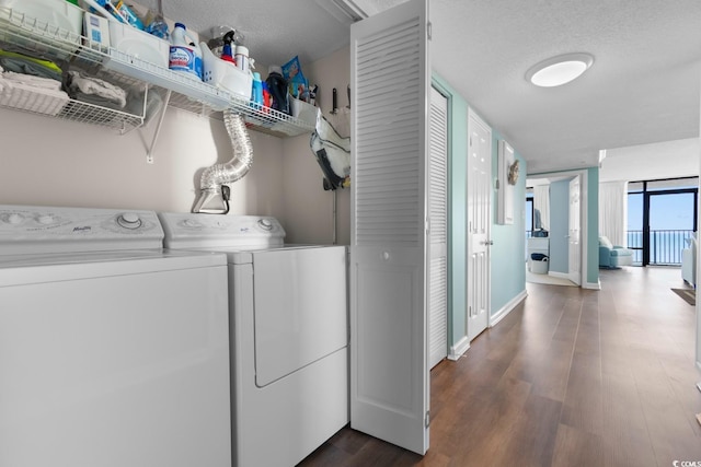 501 S Ocean Blvd Unit 1006, North Myrtle Beach, SC 29582 - laundry room featuring washing machine and clothes dryer, dark wood-style flooring, a textured ceiling, and baseboards