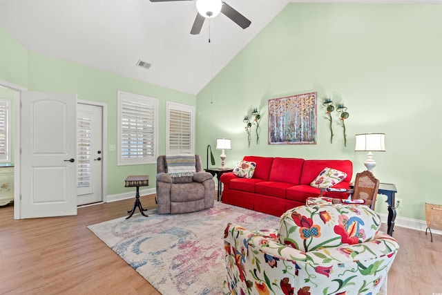 living room with high vaulted ceiling, ceiling fan, wood finished floors, and baseboards