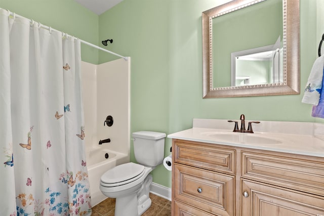 bathroom featuring toilet, baseboards, tile patterned flooring, vanity, and shower / bath combo with shower curtain