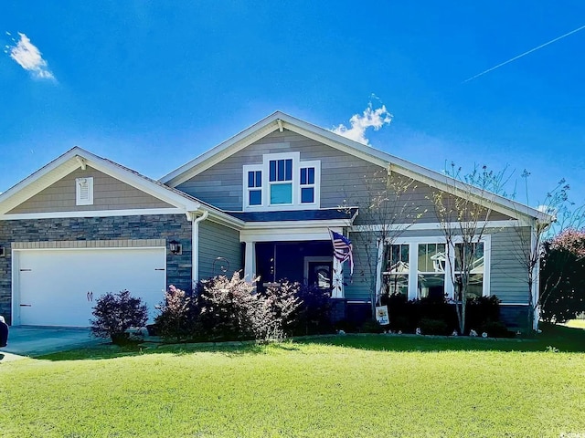 craftsman inspired home featuring a front lawn and a garage