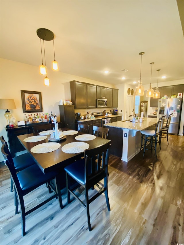 dining area featuring recessed lighting and dark wood-style floors