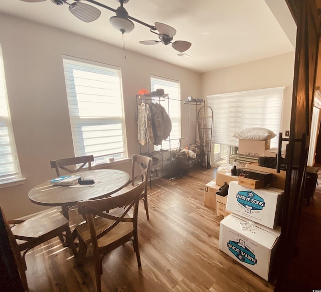 dining space featuring a ceiling fan, wood finished floors, and visible vents