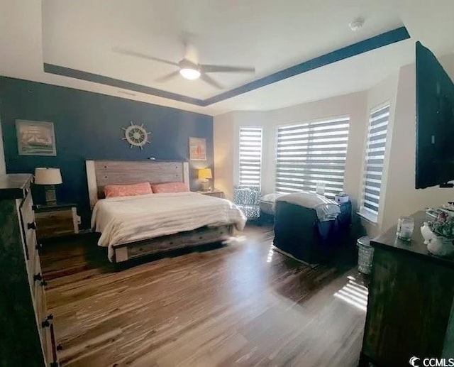 bedroom with ceiling fan and wood finished floors