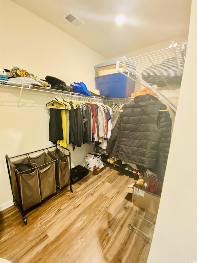 walk in closet featuring wood finished floors and visible vents
