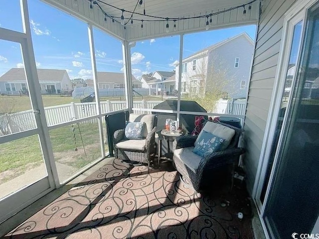 sunroom / solarium featuring a residential view