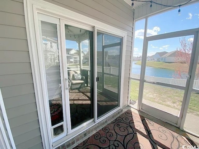 sunroom with a water view