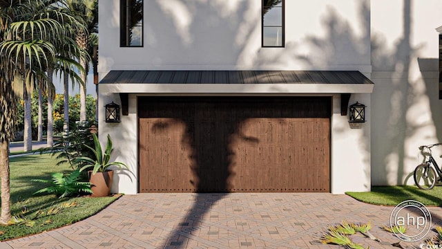 garage with decorative driveway