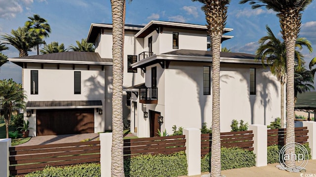 view of front of house with fence, stucco siding, metal roof, an attached garage, and driveway