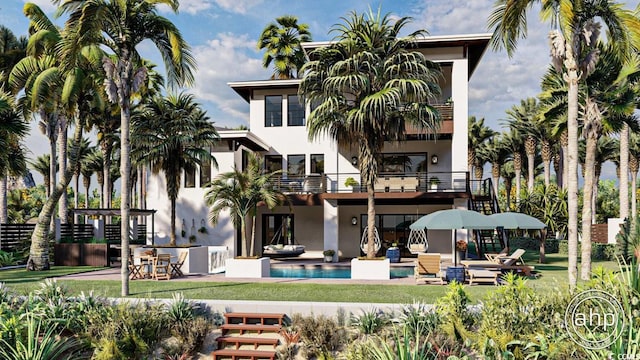 rear view of property featuring a lawn, an outdoor pool, a balcony, a patio, and stucco siding