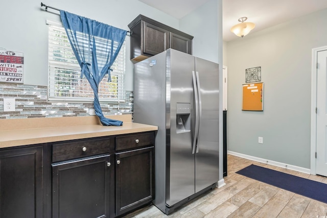 6253 Catalina Dr Unit 713, North Myrtle Beach, SC 29582 - kitchen featuring stainless steel refrigerator with ice dispenser, light wood-type flooring, light countertops, backsplash, and baseboards