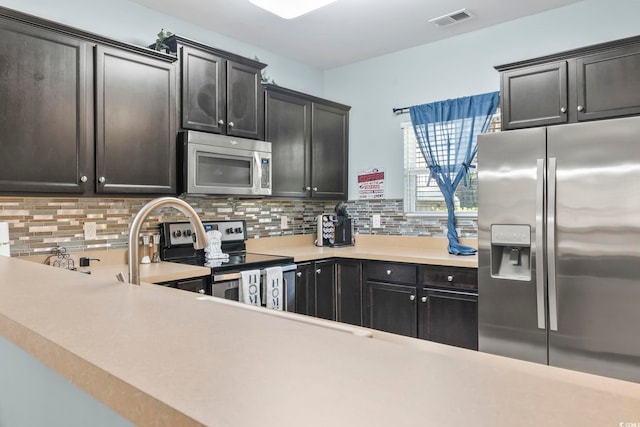 6253 Catalina Dr Unit 713, North Myrtle Beach, SC 29582 - kitchen with appliances with stainless steel finishes, backsplash, and light countertops