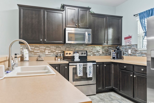 6253 Catalina Dr Unit 713, North Myrtle Beach, SC 29582 - kitchen featuring stainless steel appliances, a sink, light countertops, and tasteful backsplash