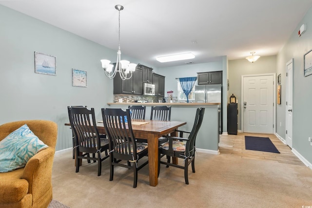 6253 Catalina Dr Unit 713, North Myrtle Beach, SC 29582 - dining space with a chandelier, light colored carpet, and baseboards