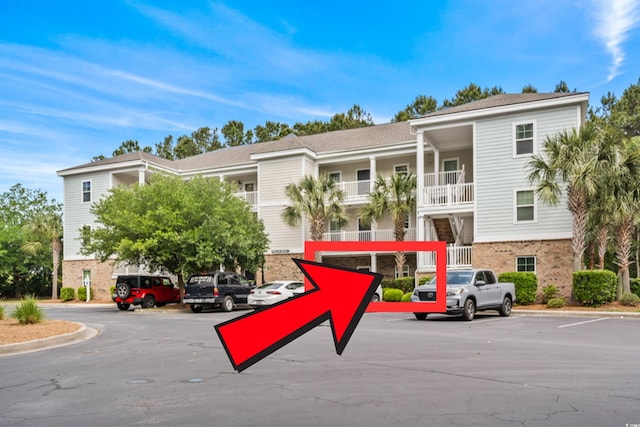 6253 Catalina Dr Unit 713, North Myrtle Beach, SC 29582 - view of building exterior with uncovered parking