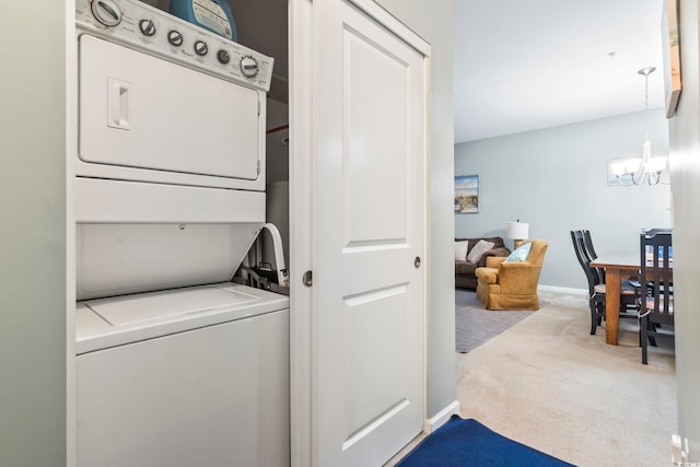 6253 Catalina Dr Unit 713, North Myrtle Beach, SC 29582 - laundry room featuring stacked washer / drying machine, carpet, a chandelier, and baseboards