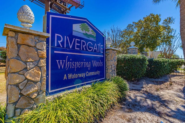 community sign featuring fence