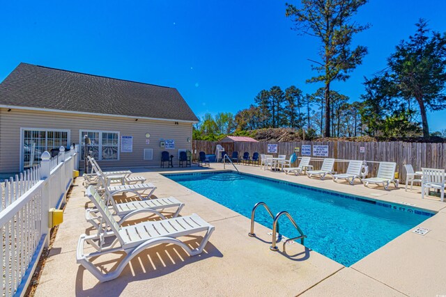 pool featuring a patio and fence private yard