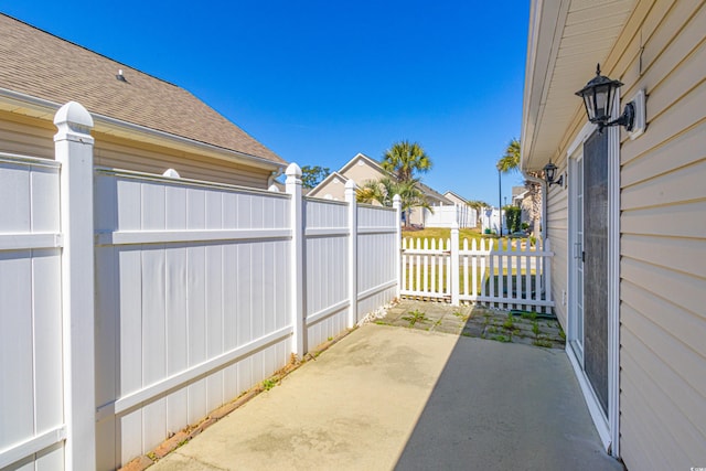 view of patio / terrace with fence and a residential view